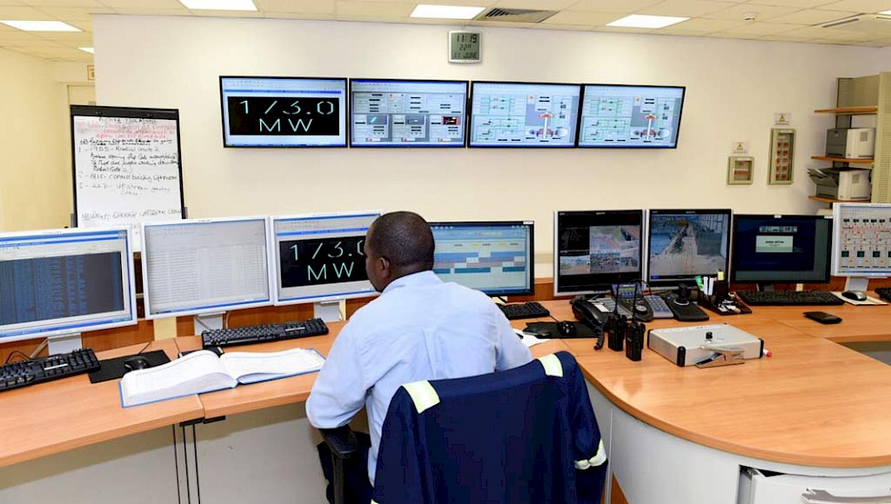 A worker in the control room at Bujagali hydroelectric power station.