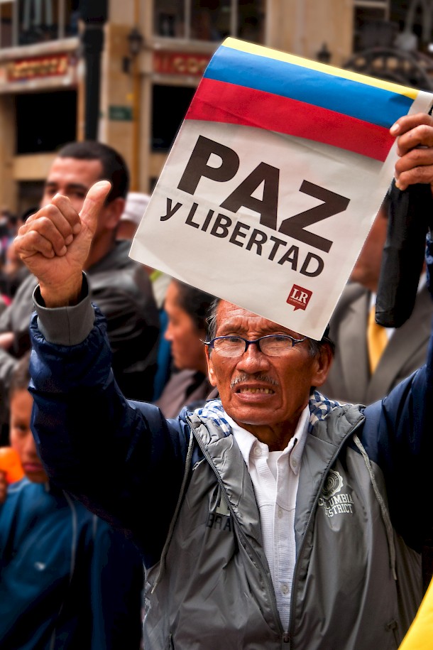 An anti-FARC protestor holds a sign demanding peace and freedom during demonstrations in Bogota. Photo: Jkraft5 | Dreamstime.com